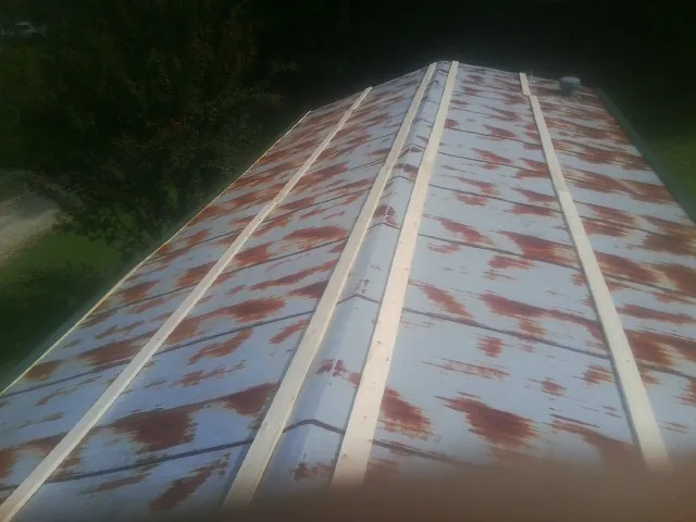 Rusted metal roof panels with new wood purlins before replacement — Storm Damage Roof Repair in Chattahoochee by Roofing Brothers