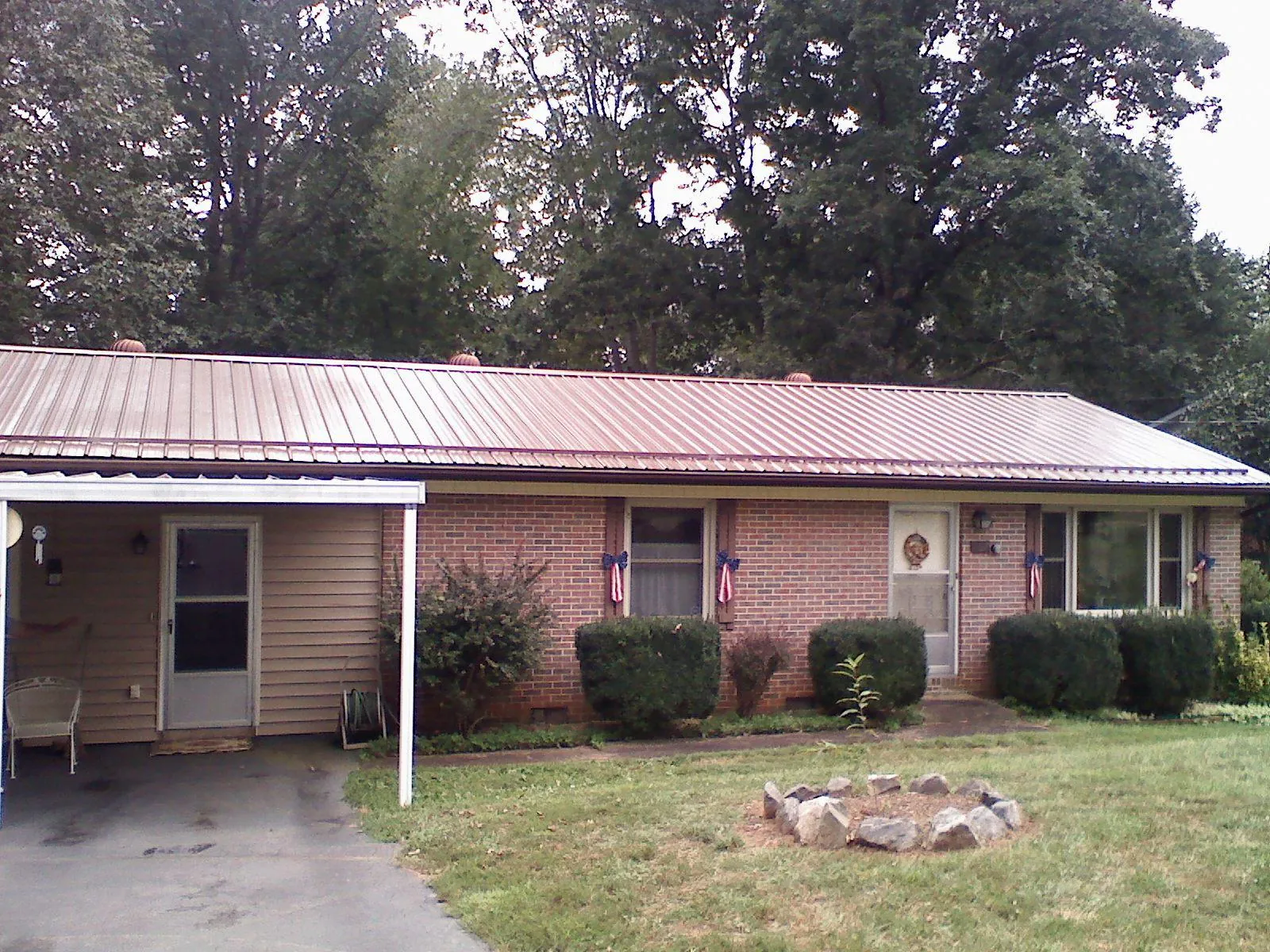 Bronze metal roof and carport on a brick ranch home — Roof Repair work by our crew in Chattahoochee