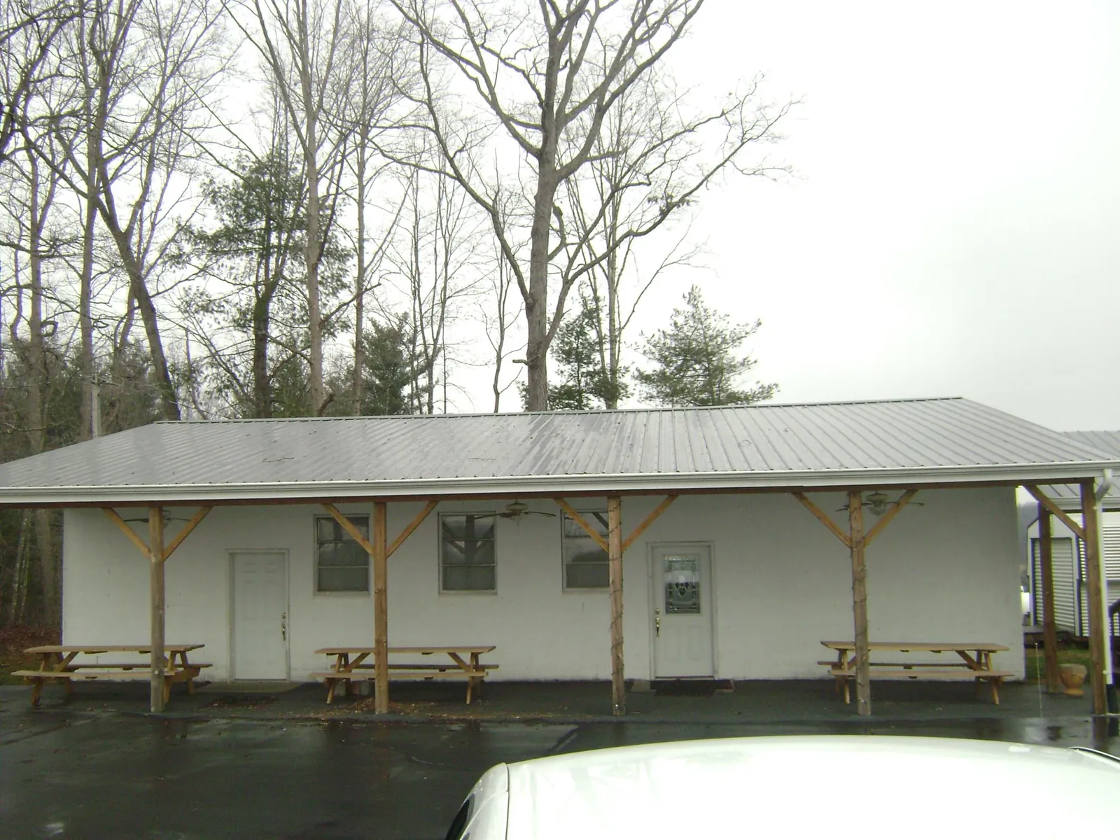 Gray metal roof over a block building with a timber post porch in Chattahoochee