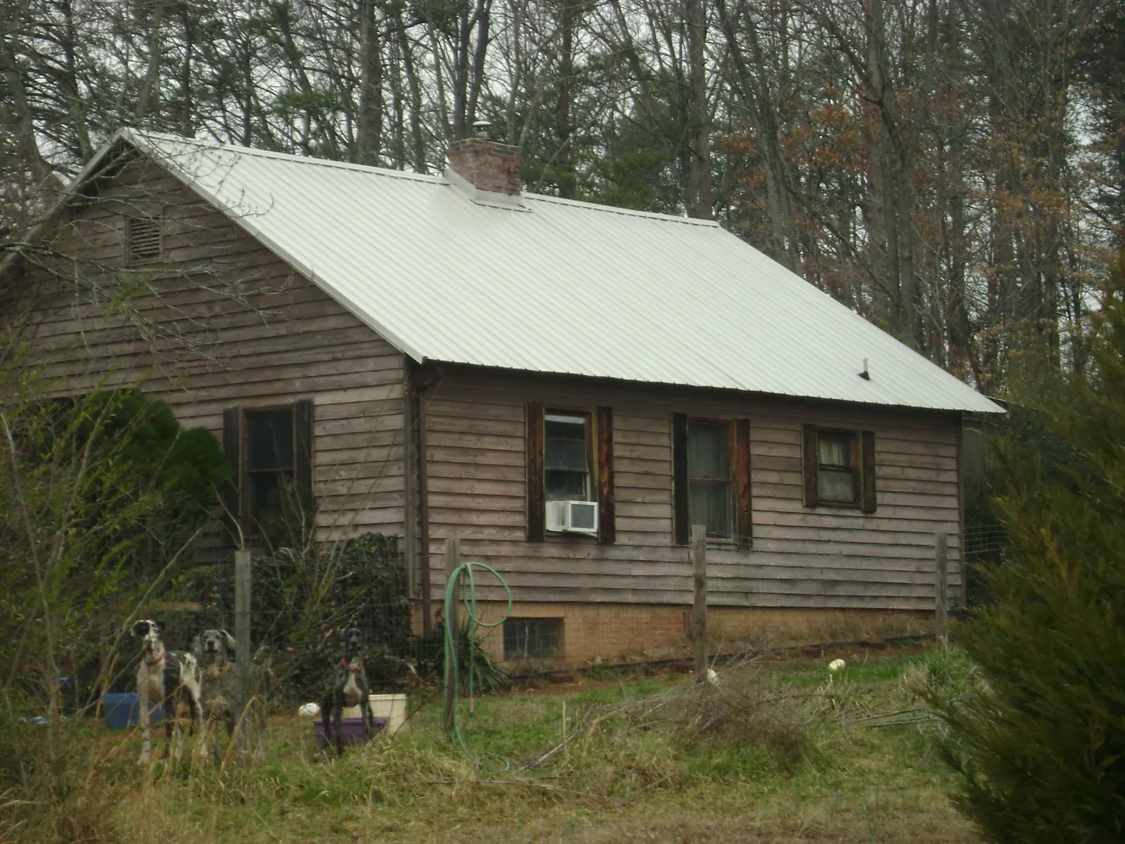 White metal roof on an old wood sided farmhouse, from a Asphalt Shingle Roof Repair job in Chattahoochee
